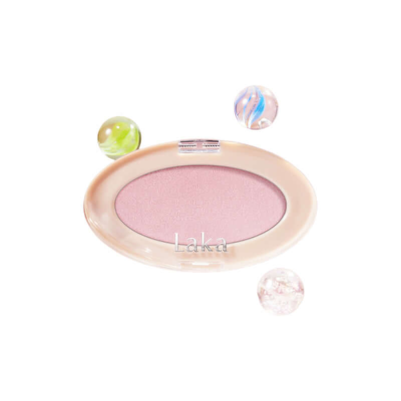 Laka Dreambeam Highlighter in a compact with marbled decorative spheres, offering a dreamy glow and vegan formula.