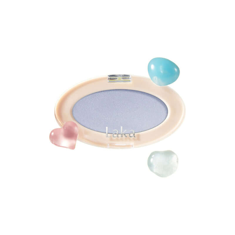 Laka Dreambeam Highlighter compact with lavender powder surrounded by colorful hearts, showcasing its vegan formula.
