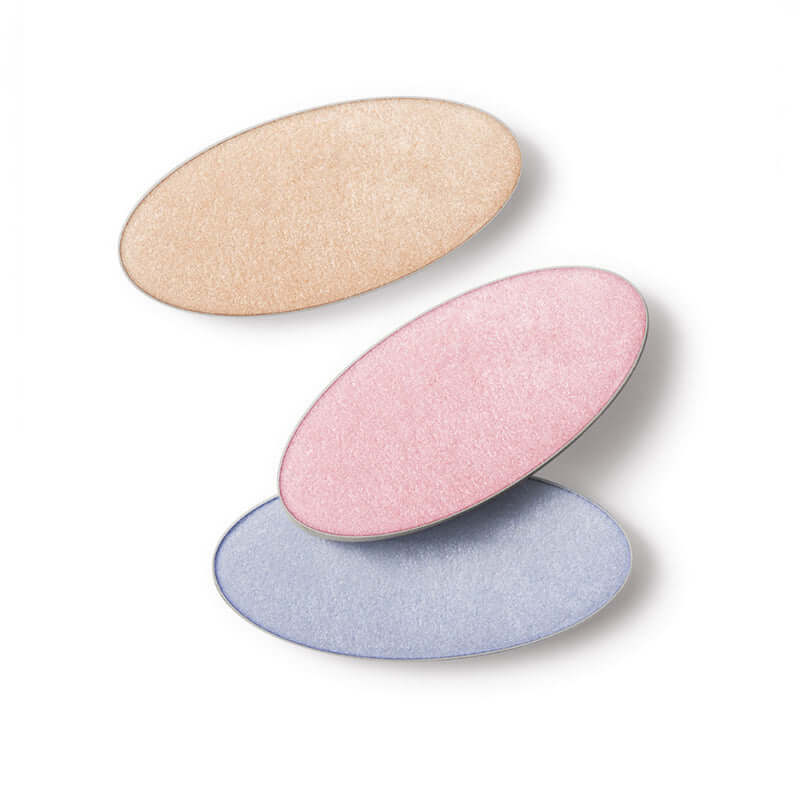 Three shades of Laka Dreambeam Highlighter powder in gold, pink, and blue on a white background.
