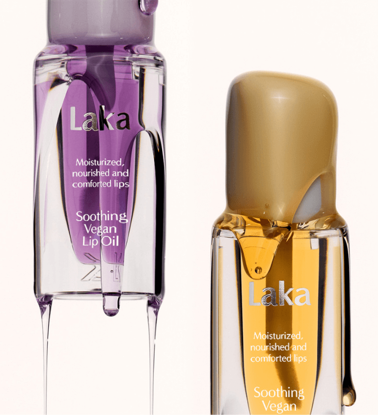 Laka Soothing Vegan Lip Oil in calming purple and nourishing beige bottles, promoting moisturized and comforted lips.