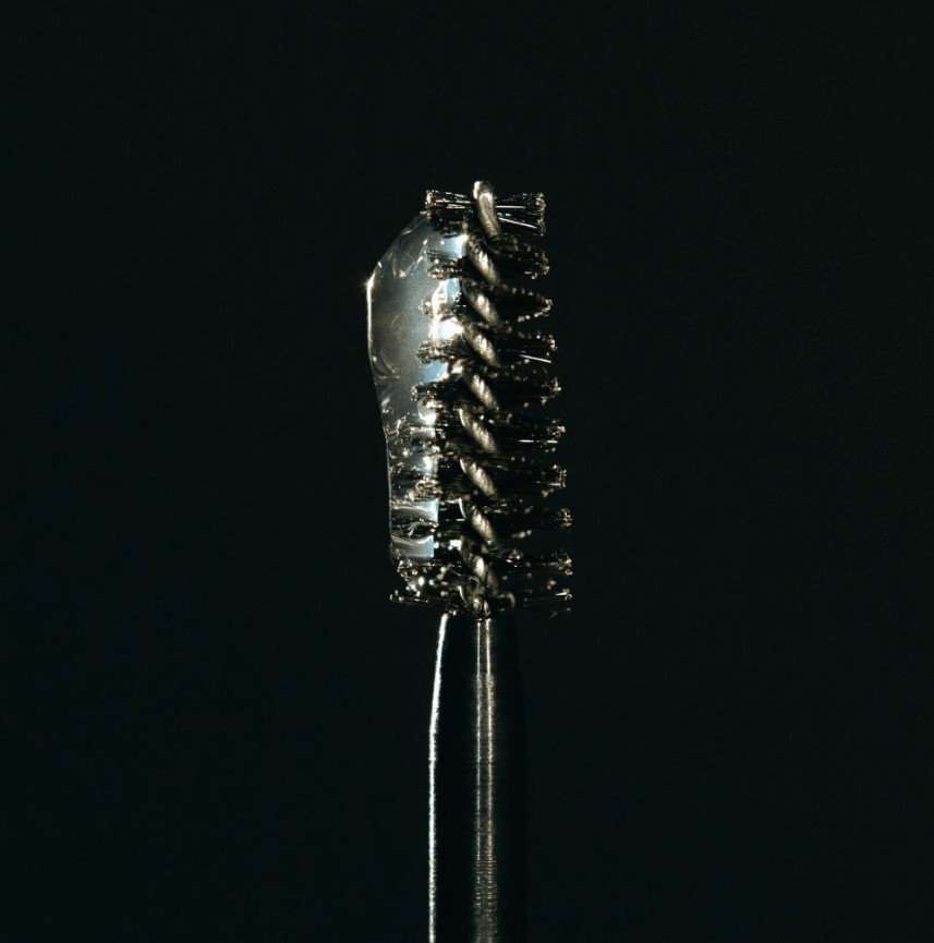 Close-up of Laka Wild Brow Shaper wand showcasing its bristles and transparent gel formula for brow styling.