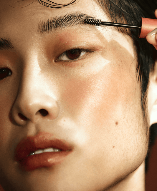 Person applying Laka Wild Brow Shaper gel for defined brows, showcasing neat brow grooming.