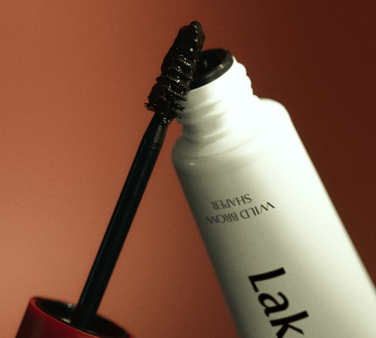 Laka Wild Brow Shaper gel and applicator brush for defined, well-groomed brows in black tint.