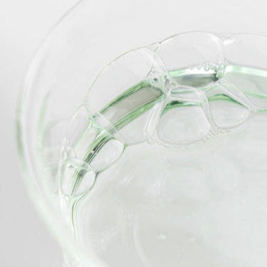 Close-up of clear gel-like texture with bubbles, showcasing the refreshing properties of toner.
