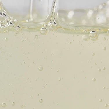Bubble-filled golden liquid texture close-up of Beauty of Joseon Pine Grove Body Wash.