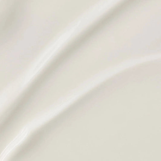 Close-up of smooth, glossy cream surface, ideal for showcasing beauty products that offer rich hydration.